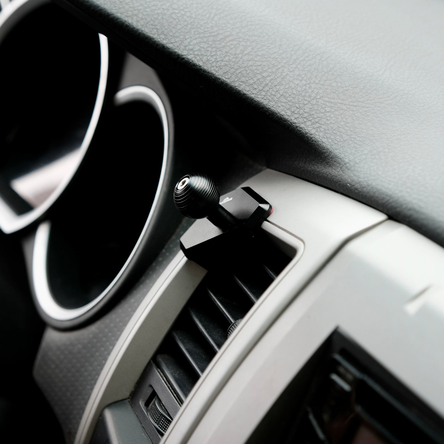 Image of Offroam MagSafe-compatible Phone Mount installed securely in Toyota Tacoma 2005-2011. This premium phone mount installs easily without drilling or glue. High force magnets hold phone on any trail, road, or track. Perfect placement without blocking screens, driver view, or air flow. Fully adjustable positioning.