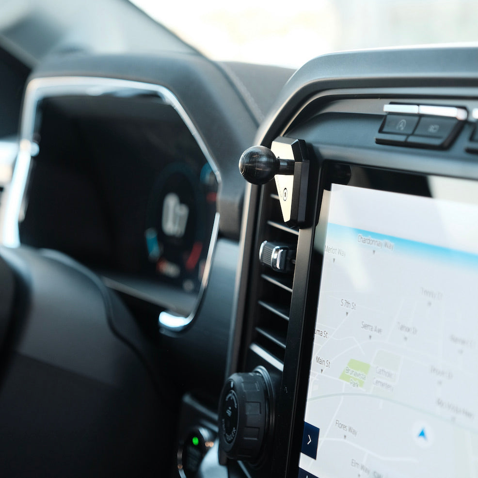 Image of Offroam Mounting Base installed securely in Ford F-150 2021-2025 | F-250/F-350 2023-2025 | F-150 Lightning (XL & PRO) 2022-2025. This premium all metal phone mounting base installs easily without drilling or glue. Perfect placement without blocking screens, driver view, or air flow.