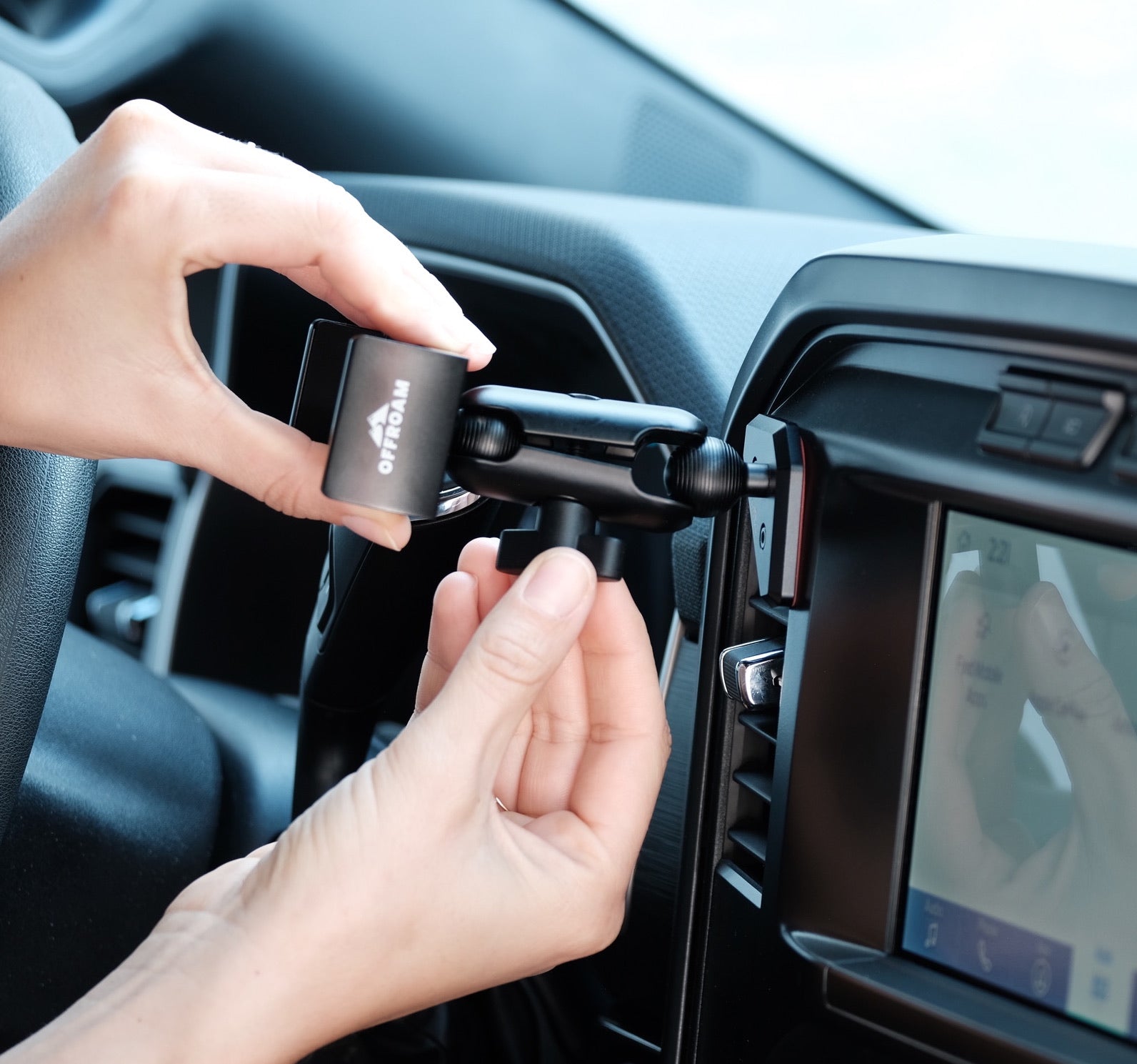 Image of Offroam Phone Mount articulating arm assembly. Offroam premium phone mounts install easily without drilling or glue. Spring loaded Universal holder for use with any phone. Perfect placement without blocking screens, driver view, or air flow. Fully adjustable positioning.