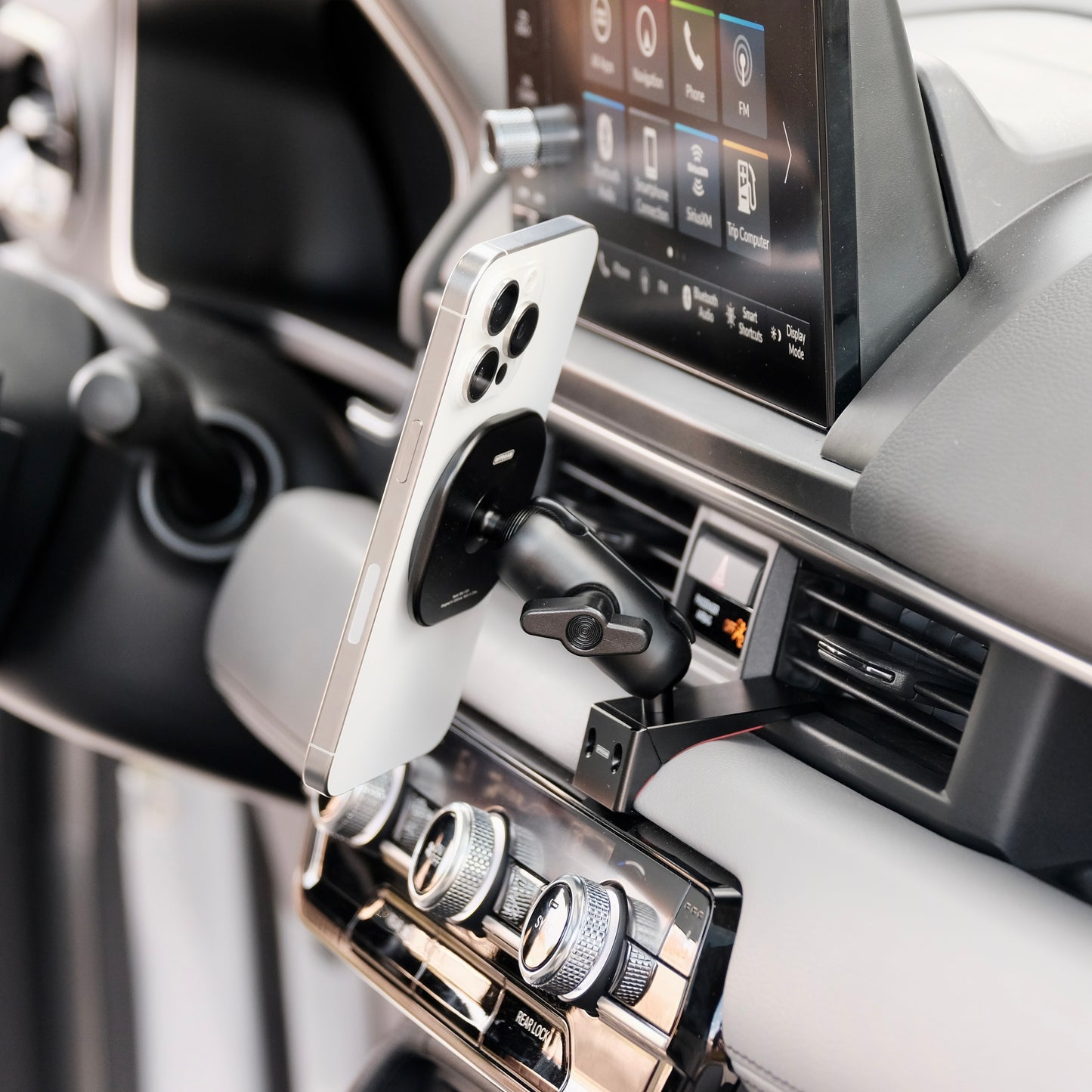 Image of Offroam MagSafe-compatible Phone Mount installed securely in Honda Pilot 2023-2025 | Passport 2026. This premium phone mount installs easily without drilling or glue. High force magnets hold phone on any trail, road, or track. Perfect placement without blocking screens, driver view, or air flow. Fully adjustable positioning.