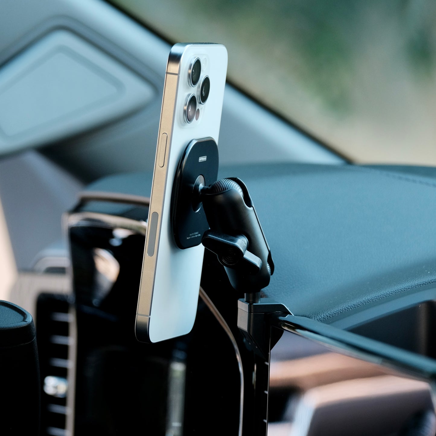 Image of Offroam MagSafe-compatible Phone Mount installed securely in Chevrolet Silverado 2022-2025 | Silverado HD 2024-2025 | GMC Sierra 1500 2022-2025 | Sierra HD 2024-2025 with 13.4-in. display. This premium phone mount installs easily without drilling or glue. High force magnets hold phone on any trail, road, or track. Perfect placement without blocking screens, driver view, or air flow. Fully adjustable positioning.