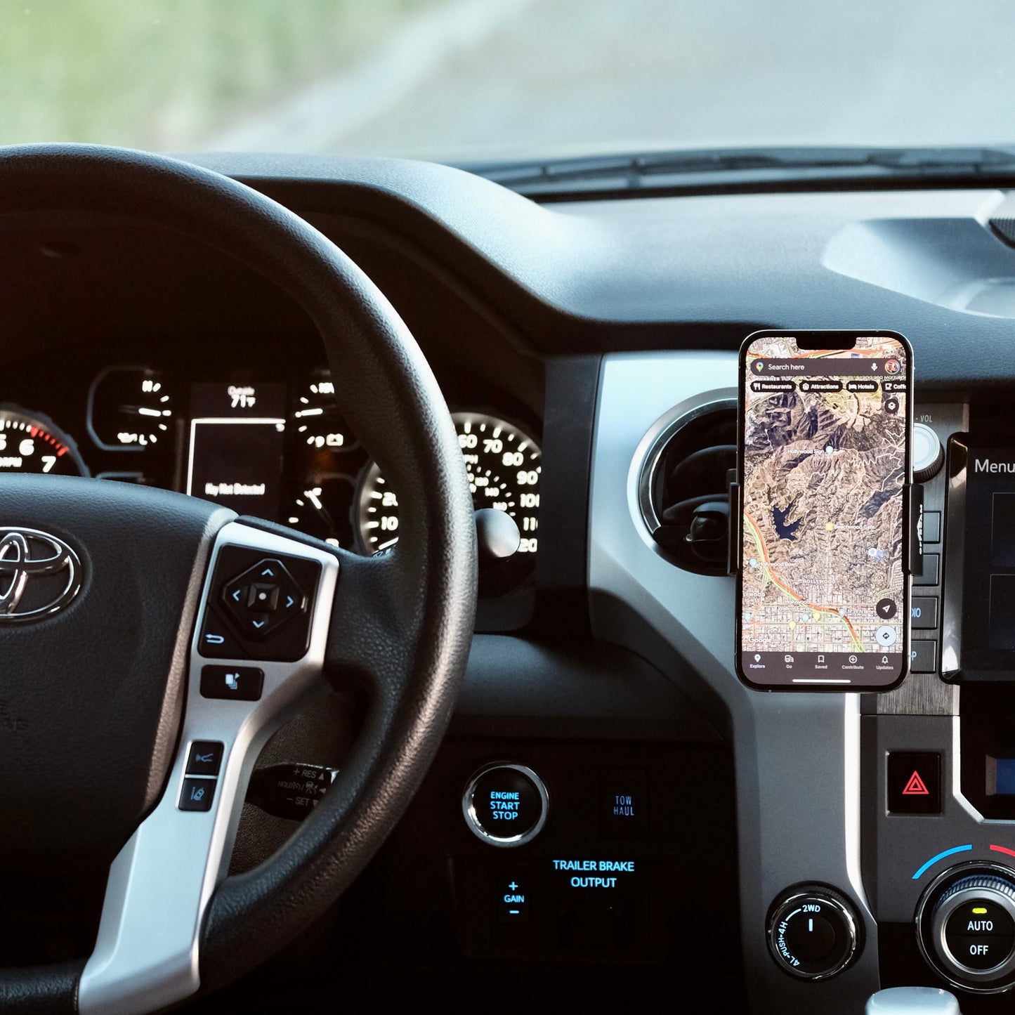 Image of Offroam Phone Mount installed securely in Toyota Tacoma 2016-2023 | Tundra 2014-2021. This premium phone mount installs easily without drilling or glue. Spring loaded Universal holder for use with any phone. Perfect placement without blocking screens, driver view, or air flow. Fully adjustable positioning.