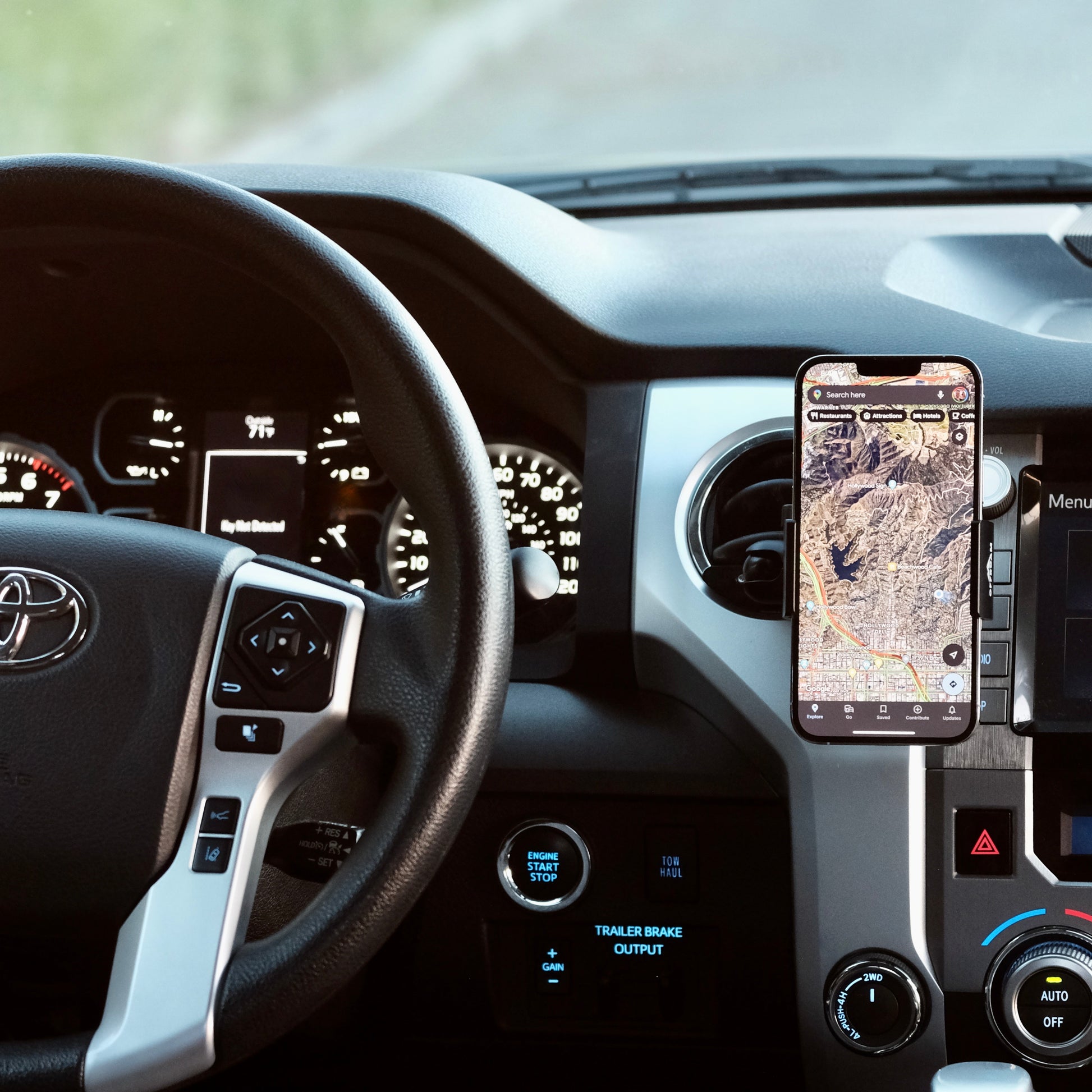 Image of Offroam Phone Mount installed securely in Toyota Tacoma 2016-2023 | Tundra 2014-2021. This premium phone mount installs easily without drilling or glue. Spring loaded Universal holder for use with any phone. Perfect placement without blocking screens, driver view, or air flow. Fully adjustable positioning.