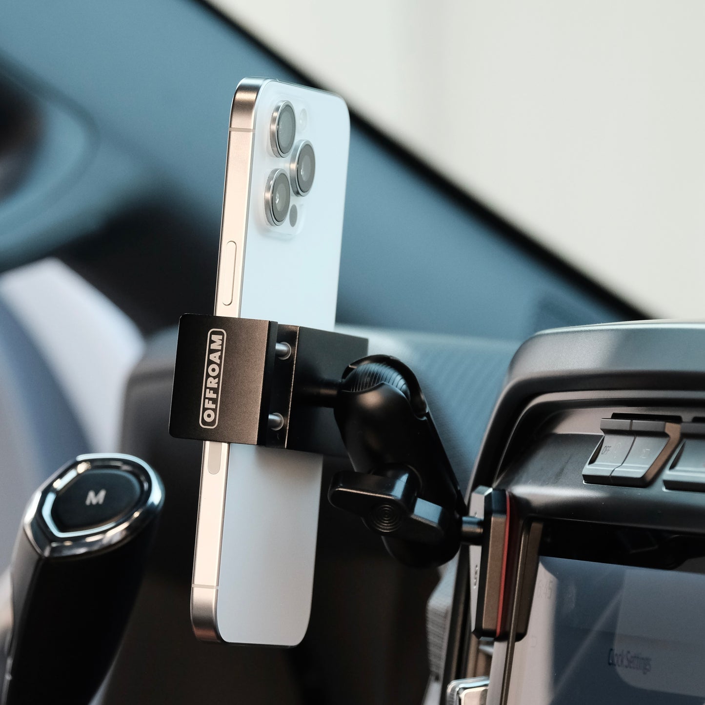 Image of Offroam Phone Mount installed securely in Ford F-150 2021-2025 | F-250/F-350 2023-2025 | F-150 Lightning (XL & PRO) 2022-2025. This premium phone mount installs easily without drilling or glue. Spring loaded Universal holder for use with any phone. Perfect placement without blocking screens, driver view, or air flow. Fully adjustable positioning.