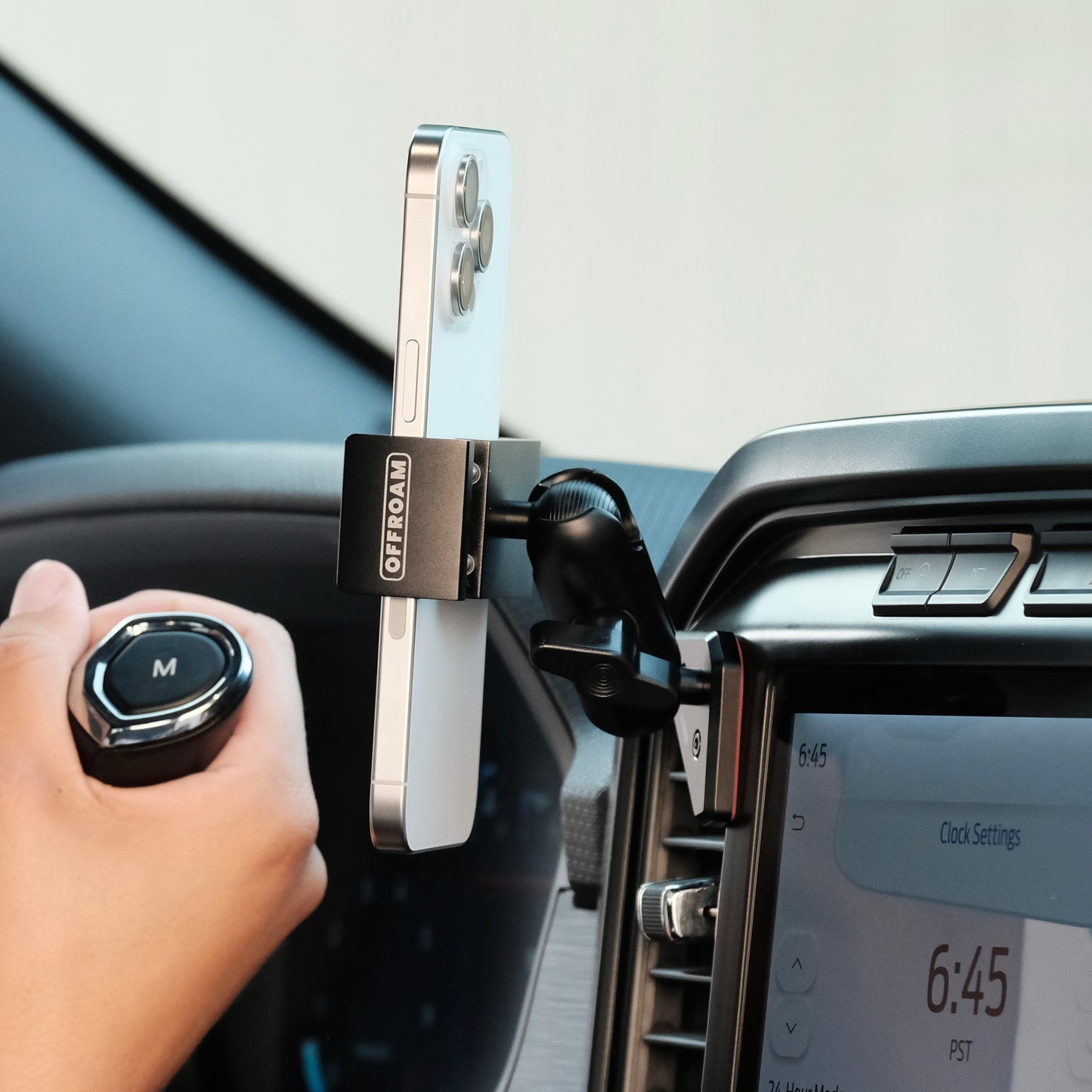 Image of Offroam Phone Mount installed securely in Ford F-150 2021-2025 | F-250/F-350 2023-2025 | F-150 Lightning (XL & PRO) 2022-2025. This premium phone mount installs easily without drilling or glue. Spring loaded Universal holder for use with any phone. Perfect placement without blocking screens, driver view, or air flow. Fully adjustable positioning.