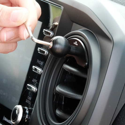 Image of Offroam Mounting Base installed securely in Toyota Tacoma 2016-2023 | Tundra 2014-2021. This premium all metal phone mounting base installs easily without drilling or glue. Perfect placement without blocking screens, driver view, or air flow.