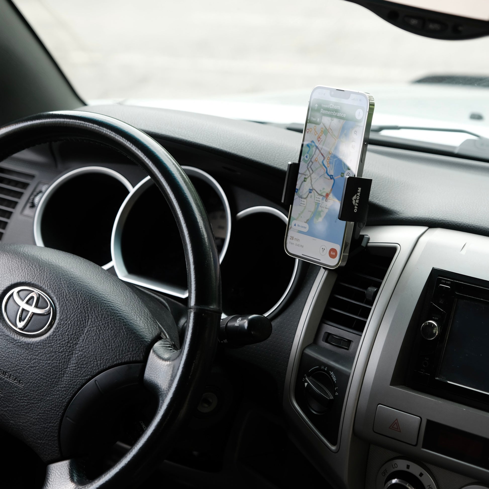 Image of Offroam Phone Mount installed securely in Toyota Tacoma 2005-2011. This premium phone mount installs easily without drilling or glue. Spring loaded Universal holder for use with any phone. Perfect placement without blocking screens, driver view, or air flow. Fully adjustable positioning.