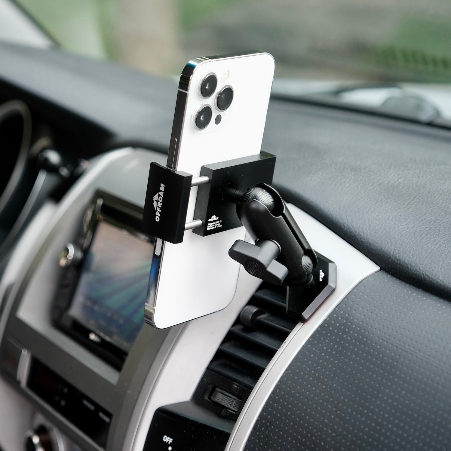 Image of Offroam Phone Mount installed securely in Toyota Tacoma 2005-2011. This premium phone mount installs easily without drilling or glue. Spring loaded Universal holder for use with any phone. Perfect placement without blocking screens, driver view, or air flow. Fully adjustable positioning.