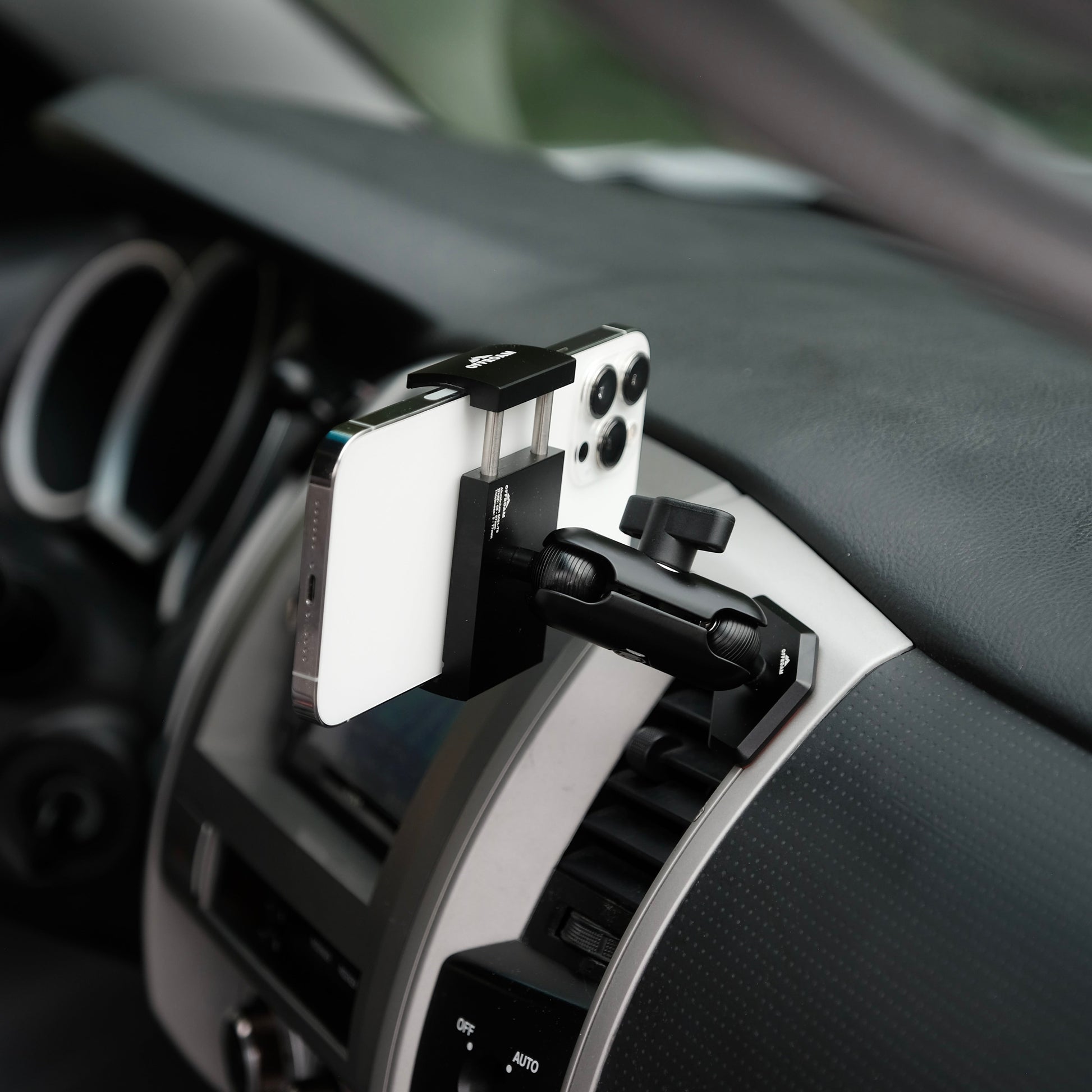 Image of Offroam Phone Mount installed securely in Toyota Tacoma 2005-2011. This premium phone mount installs easily without drilling or glue. Spring loaded Universal holder for use with any phone. Perfect placement without blocking screens, driver view, or air flow. Fully adjustable positioning.
