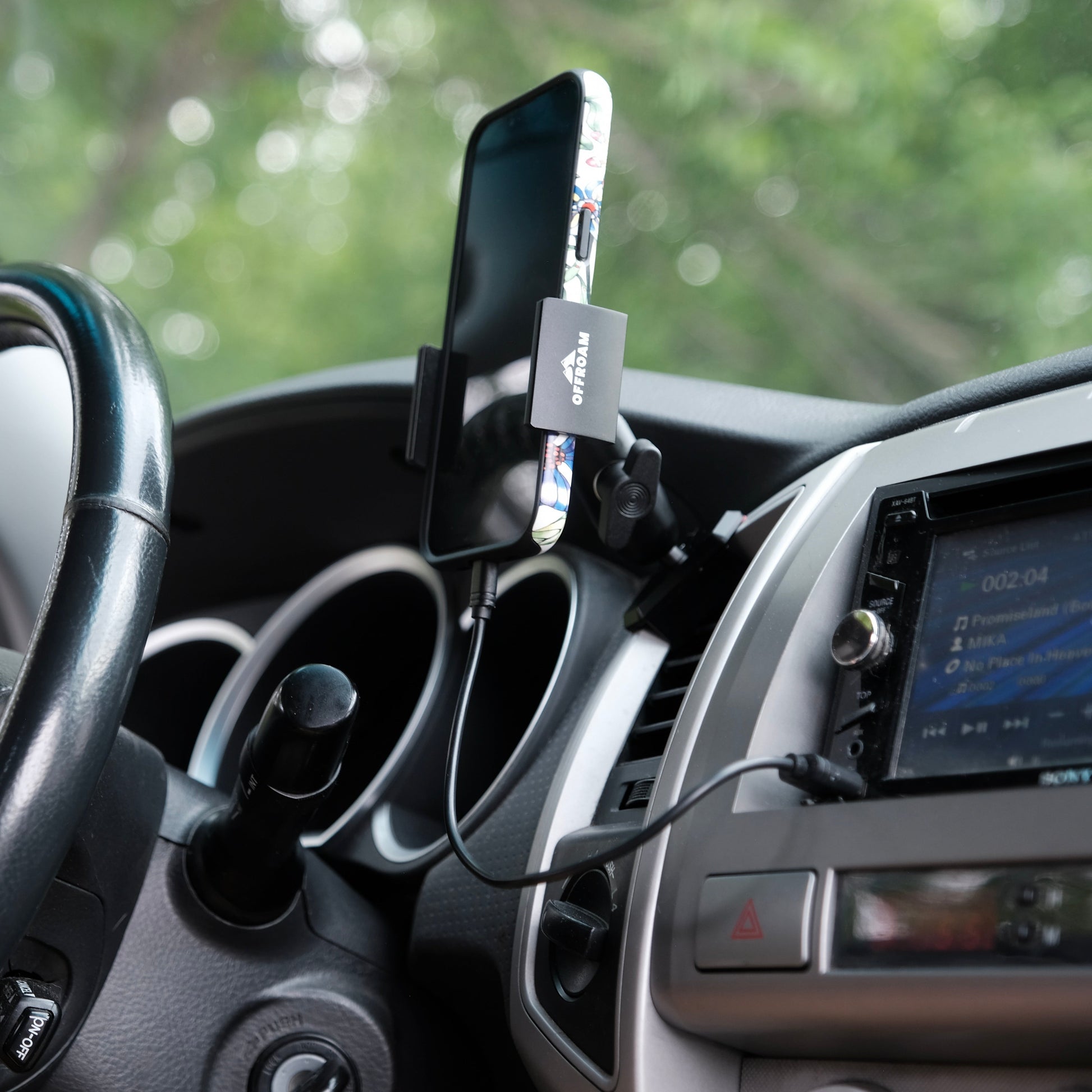 Image of Offroam Phone Mount installed securely in Toyota Tacoma 2005-2011. This premium phone mount installs easily without drilling or glue. Spring loaded Universal holder for use with any phone. Perfect placement without blocking screens, driver view, or air flow. Fully adjustable positioning.