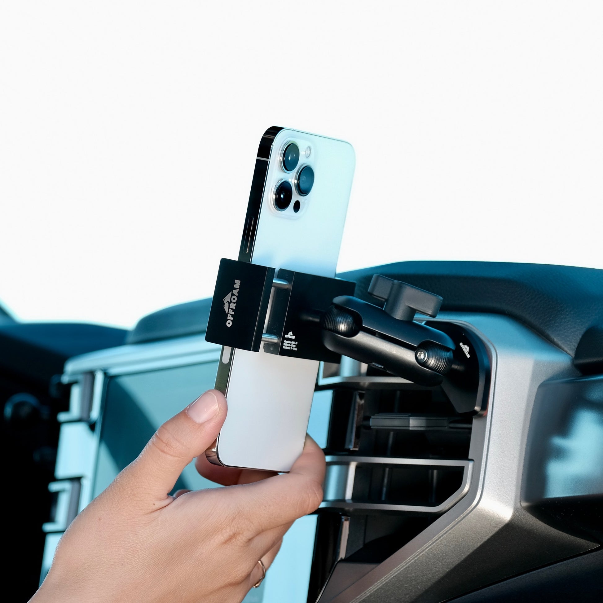 Image of Offroam Phone Mount installed securely in Toyota Tundra 2022-2025 | Sequoia 2023-2025. This premium phone mount installs easily without drilling or glue. Spring loaded Universal holder for use with any phone. Perfect placement without blocking screens, driver view, or air flow. Fully adjustable positioning.