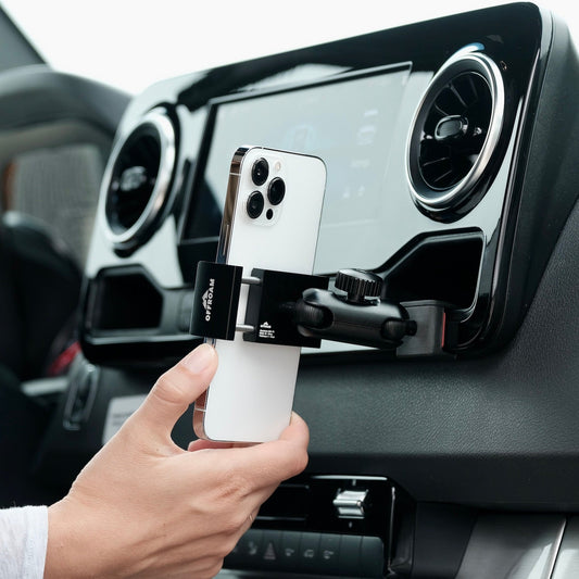 Image of Offroam Phone Mount installed securely in Mercedes-Benz Sprinter 2019-2025. This premium phone mount installs easily without drilling or glue. Spring loaded Universal holder for use with any phone. Perfect placement without blocking screens, driver view, or air flow. Fully adjustable positioning.