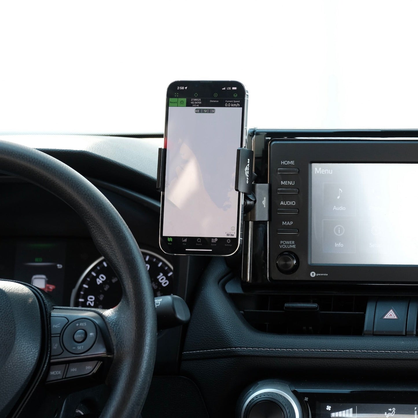 Image of Offroam Phone Mount installed securely in Toyota RAV4 2019-2025 with 7-in. or 8-in. Toyota Audio Multimedia. This premium phone mount installs easily without drilling or glue. Spring loaded Universal holder for use with any phone. Perfect placement without blocking screens, driver view, or air flow. Fully adjustable positioning.