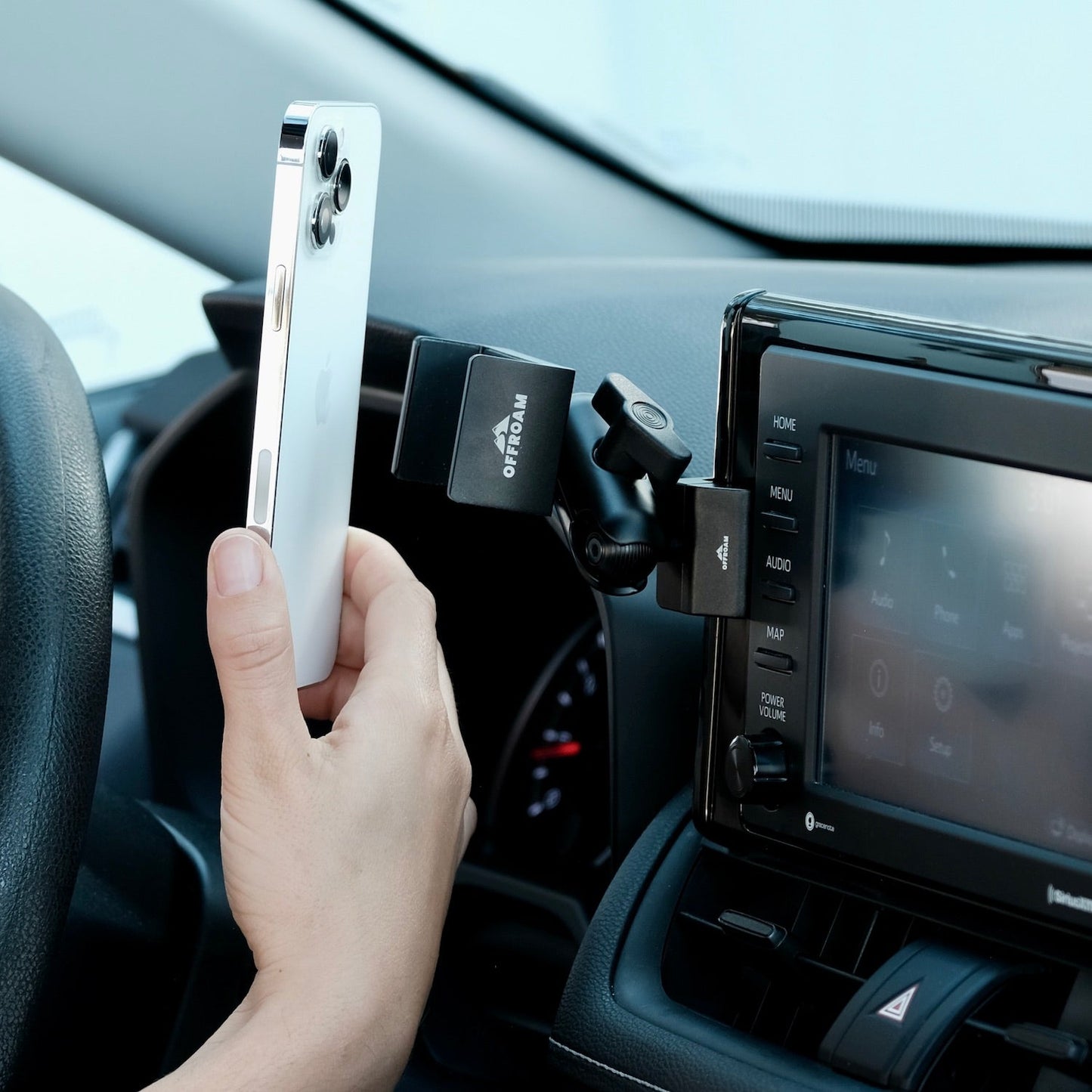 Image of Offroam Phone Mount installed securely in Toyota RAV4 2019-2025 with 7-in. or 8-in. Toyota Audio Multimedia. This premium phone mount installs easily without drilling or glue. Spring loaded Universal holder for use with any phone. Perfect placement without blocking screens, driver view, or air flow. Fully adjustable positioning.