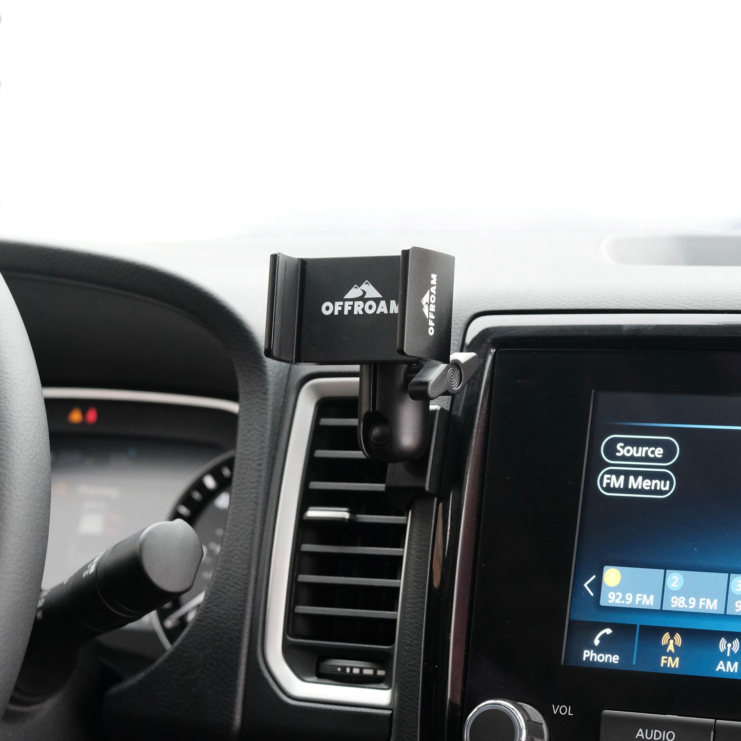 Image of Offroam Phone Mount installed securely in Nissan Frontier 2022-2024. This premium phone mount installs easily without drilling or glue. Spring loaded Universal holder for use with any phone. Perfect placement without blocking screens, driver view, or air flow. Fully adjustable positioning.
