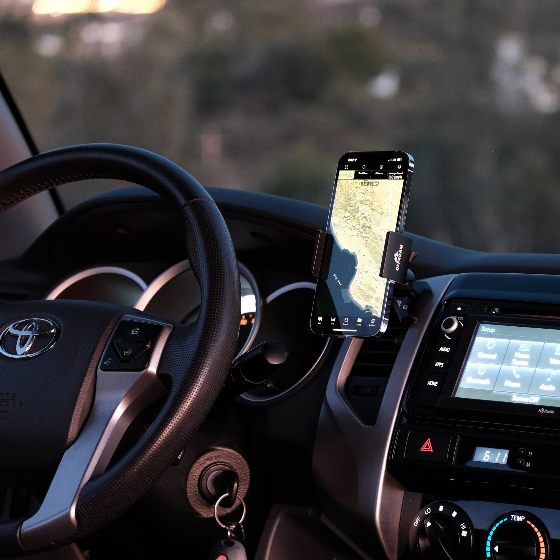 Image of Offroam Phone Mount installed securely in Toyota Tacoma 2012-2015. This premium phone mount installs easily without drilling or glue. Spring loaded Universal holder for use with any phone. Perfect placement without blocking screens, driver view, or air flow. Fully adjustable positioning.