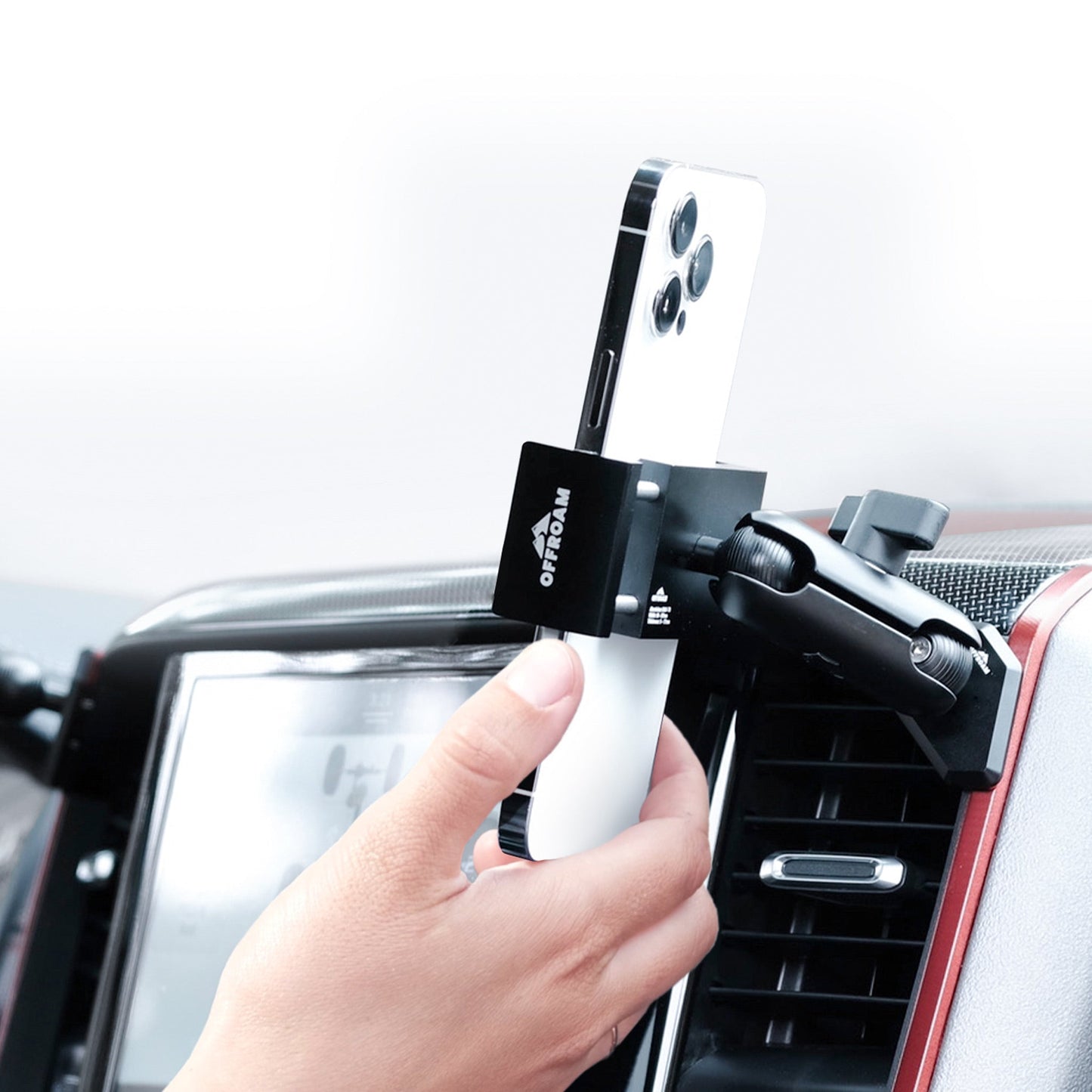 Image of Offroam Phone Mount installed securely in Ram 1500/2500/3500 2019-2025. This premium phone mount installs easily without drilling or glue. Spring loaded Universal holder for use with any phone. Perfect placement without blocking screens, driver view, or air flow. Fully adjustable positioning.