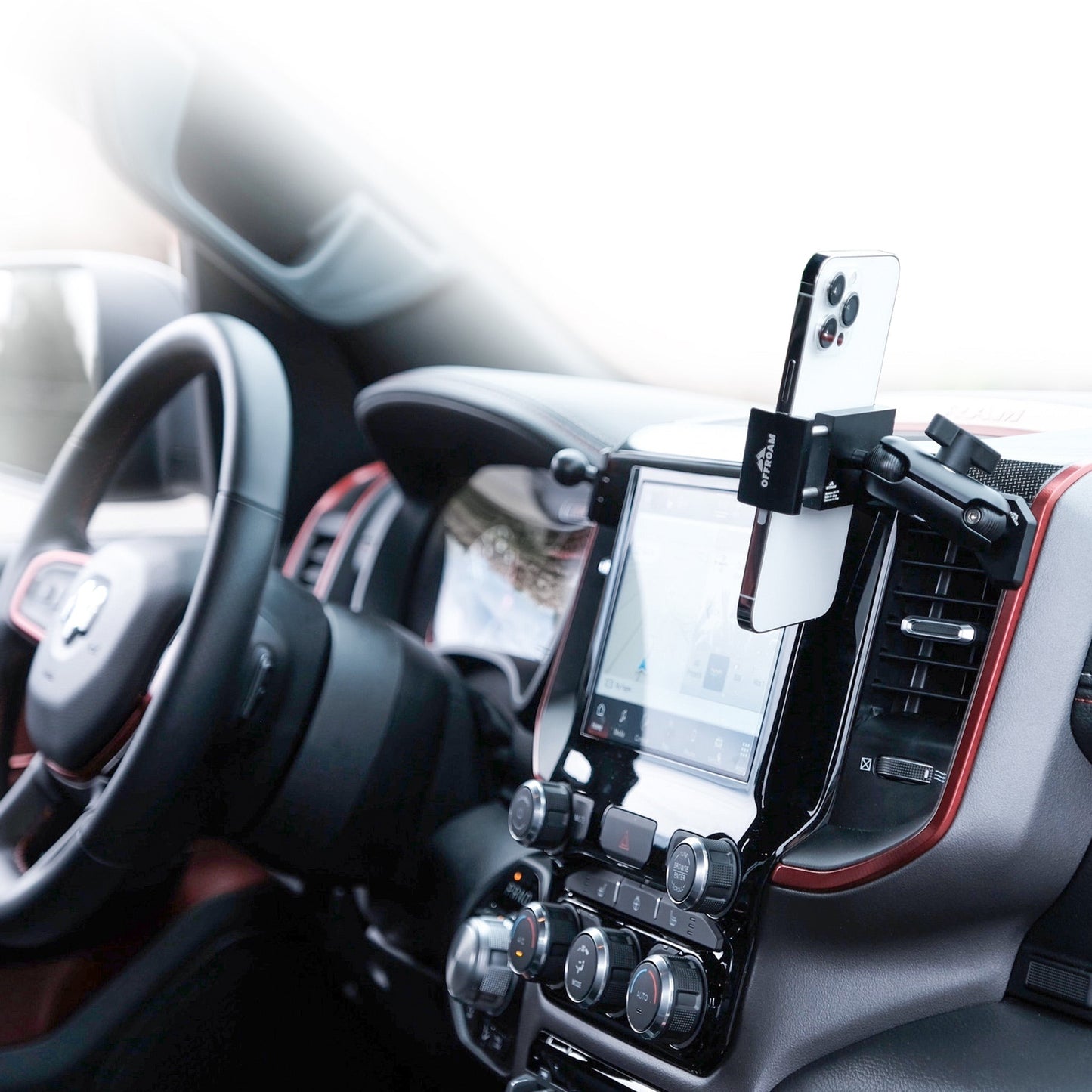 Image of Offroam Phone Mount installed securely in Ram 1500/2500/3500 2019-2025. This premium phone mount installs easily without drilling or glue. Spring loaded Universal holder for use with any phone. Perfect placement without blocking screens, driver view, or air flow. Fully adjustable positioning.