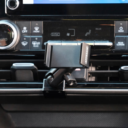 Image of Offroam Phone Mount installed securely in Toyota Highlander 2020-2026. This premium phone mount installs easily without drilling or glue. Spring loaded Universal holder for use with any phone. Perfect placement without blocking screens, driver view, or air flow. Fully adjustable positioning.