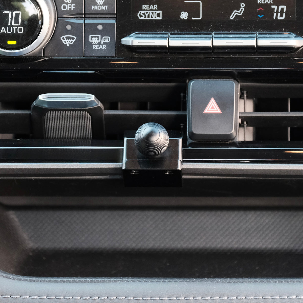 Image of Offroam Mounting Base installed securely in Toyota Highlander 2020-2026. This premium all metal phone mounting base installs easily without drilling or glue. Perfect placement without blocking screens, driver view, or air flow.