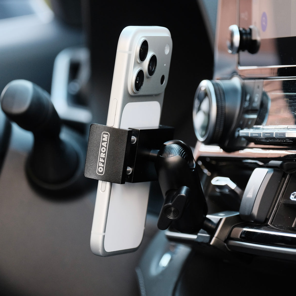Image of Offroam Phone Mount installed securely in Toyota Highlander 2020-2026. This premium phone mount installs easily without drilling or glue. Spring loaded Universal holder for use with any phone. Perfect placement without blocking screens, driver view, or air flow. Fully adjustable positioning.