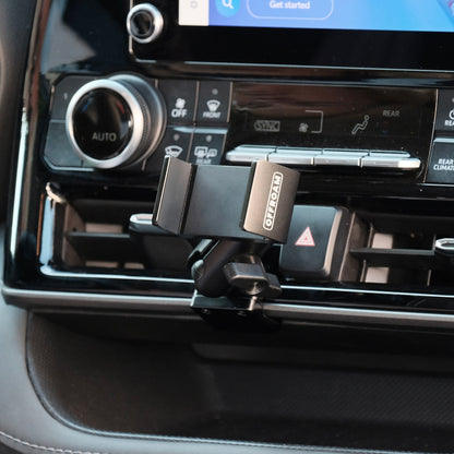 Image of Offroam Phone Mount installed securely in Toyota Highlander 2020-2026. This premium phone mount installs easily without drilling or glue. Spring loaded Universal holder for use with any phone. Perfect placement without blocking screens, driver view, or air flow. Fully adjustable positioning.