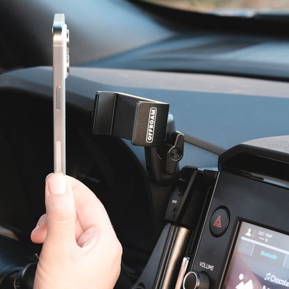 Image of Offroam Phone Mount installed securely in Subaru Forester 2025-2026. This premium phone mount installs easily without drilling or glue. Spring loaded Universal holder for use with any phone. Perfect placement without blocking screens, driver view, or air flow. Fully adjustable positioning.