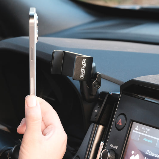 Image of Offroam Phone Mount installed securely in Subaru Forester 2025-2026. This premium phone mount installs easily without drilling or glue. Spring loaded Universal holder for use with any phone. Perfect placement without blocking screens, driver view, or air flow. Fully adjustable positioning.