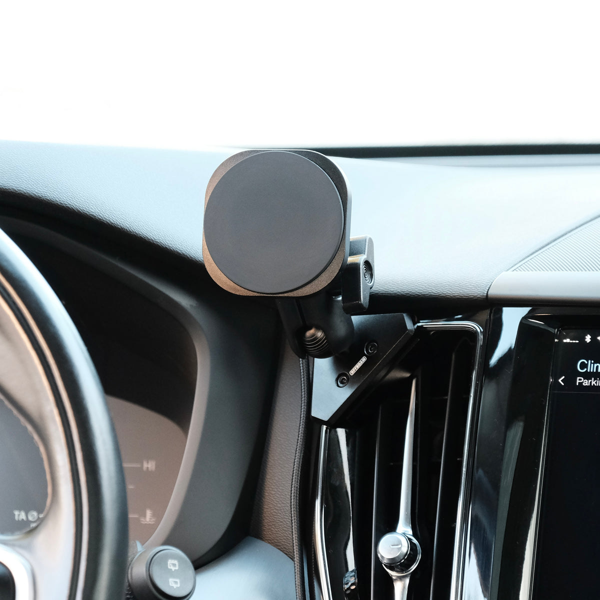 Offroam phone mount attached to the dashboard of Volvo XC60 securely. Featuring a Qi2 charging holder with powerful magnets for secure hold