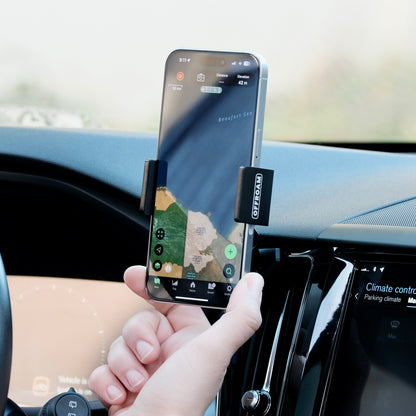 Offroam universal phone mont installed on  Volvo XC60 2018-2026. Does not block air flow and holds securely without glue or drilling. Secure mechanical holder for one-hand use and off-roading.