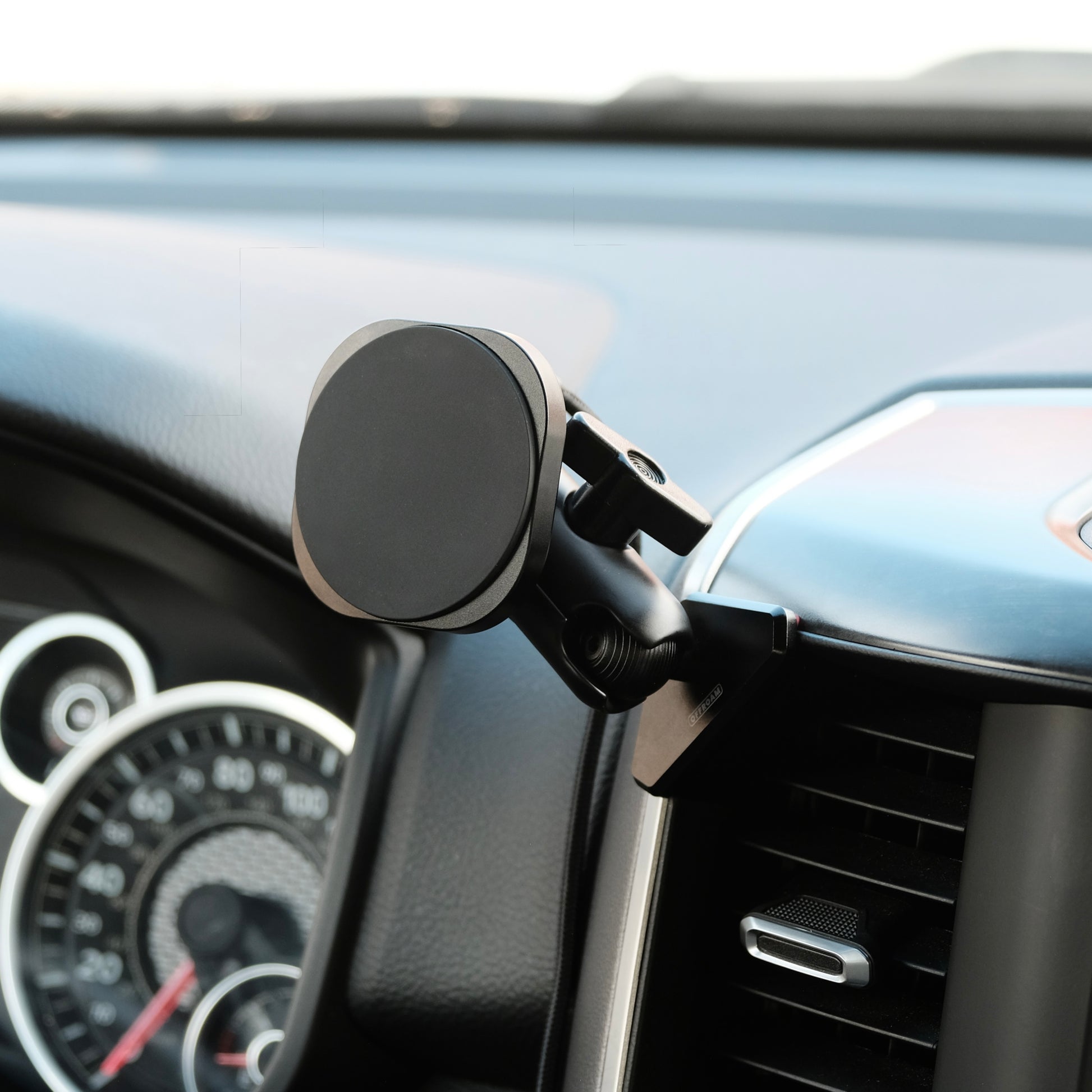 Image of Offroam MagSafe-compatible Phone Mount installed securely in Ram 1500/2500/3500 2019-2026. This premium phone mount installs easily without drilling or glue. High force magnets hold phone on any trail, road, or track. Perfect placement without blocking screens, driver view, or air flow. Fully adjustable positioning.