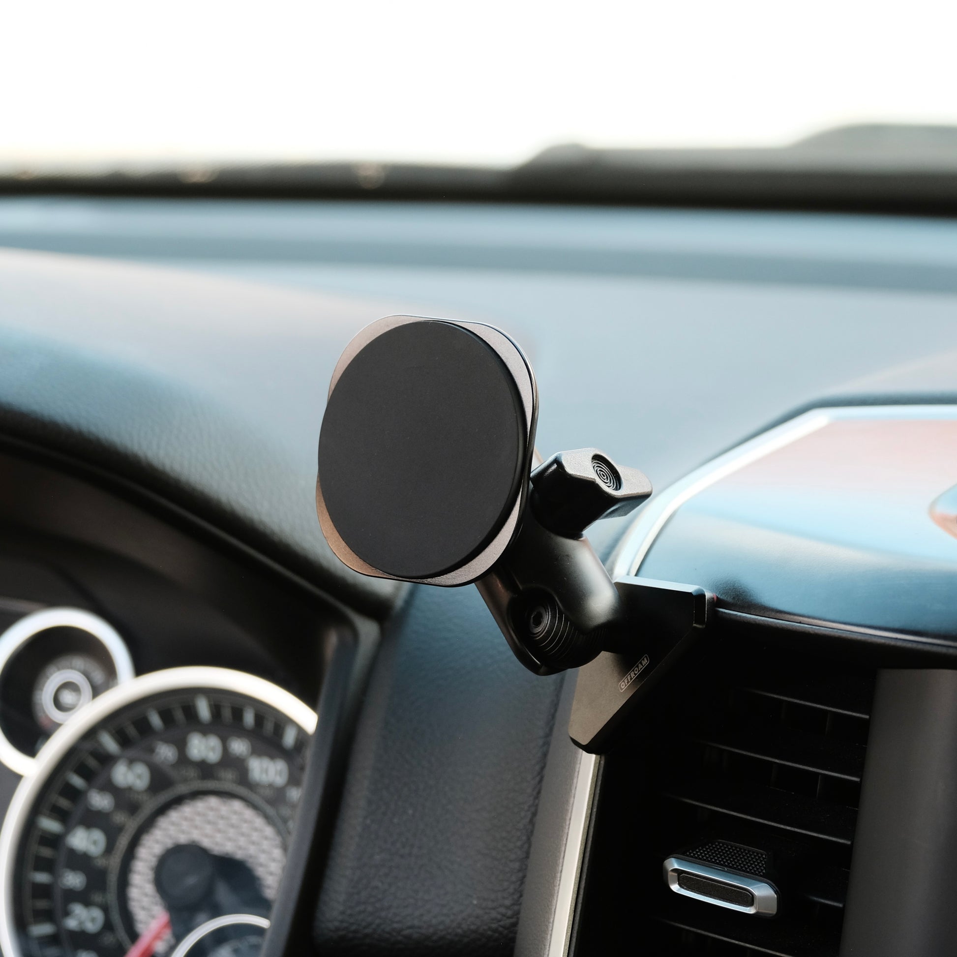 Image of Offroam MagSafe-compatible Phone Mount installed securely in Ram 1500/2500/3500 2019-2026. This premium phone mount installs easily without drilling or glue. High force magnets hold phone on any trail, road, or track. Perfect placement without blocking screens, driver view, or air flow. Fully adjustable positioning.