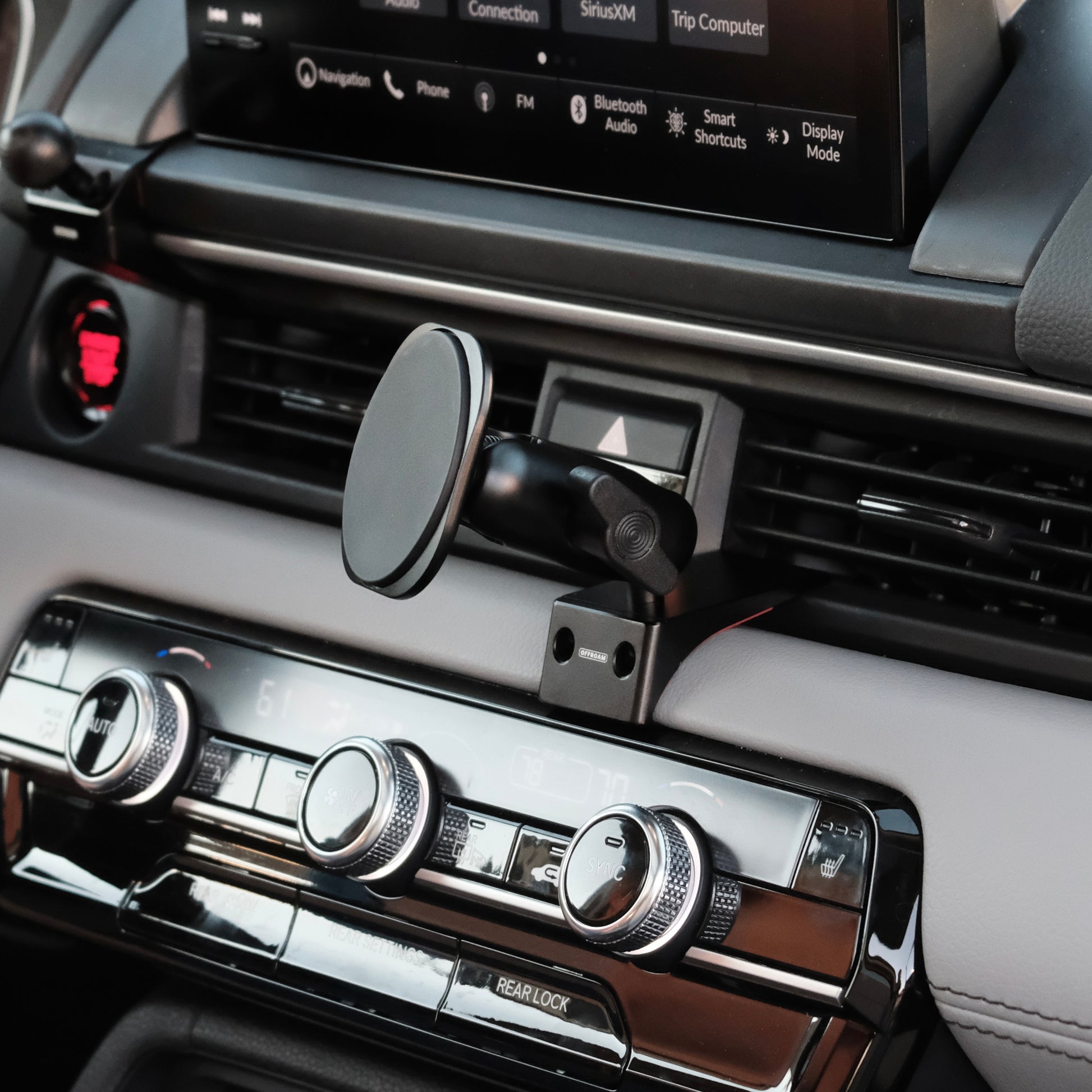 Image of Offroam MagSafe-compatible Phone Mount installed securely in Honda Pilot 2023-2025 | Passport 2026. This premium phone mount installs easily without drilling or glue. High force magnets hold phone on any trail, road, or track. Perfect placement without blocking screens, driver view, or air flow. Fully adjustable positioning.