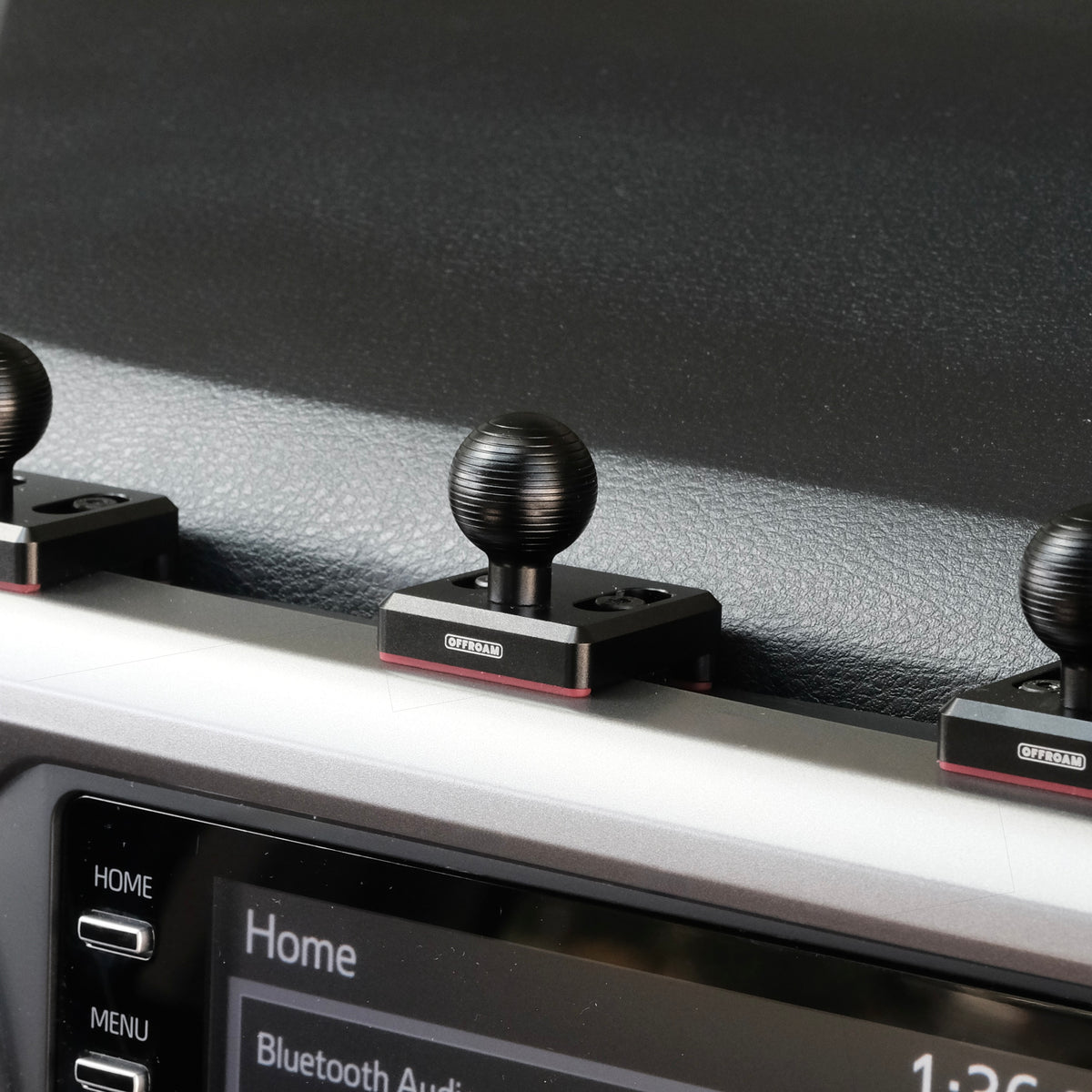 Image of Offroam Mounting Bases installed securely in Toyota Tacoma 2016-2023. This premium all metal phone mounting base installs easily without drilling or glue. Perfect placement without blocking screens, driver view, or air flow.