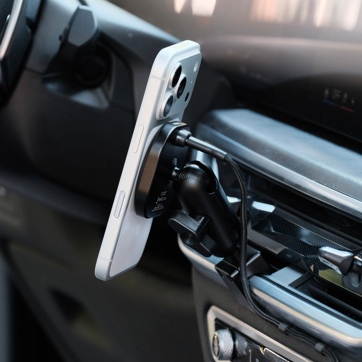 Image of Offroam MagSafe-compatible Phone Mount installed securely in BBMW X5 2024-2026 | X6 2024-2027 | X7 2023-2027. This premium phone mount installs easily without drilling or glue. High force magnets hold phone on any trail, road, or track. Perfect placement without blocking screens, driver view, or air flow. Fully adjustable positioning.