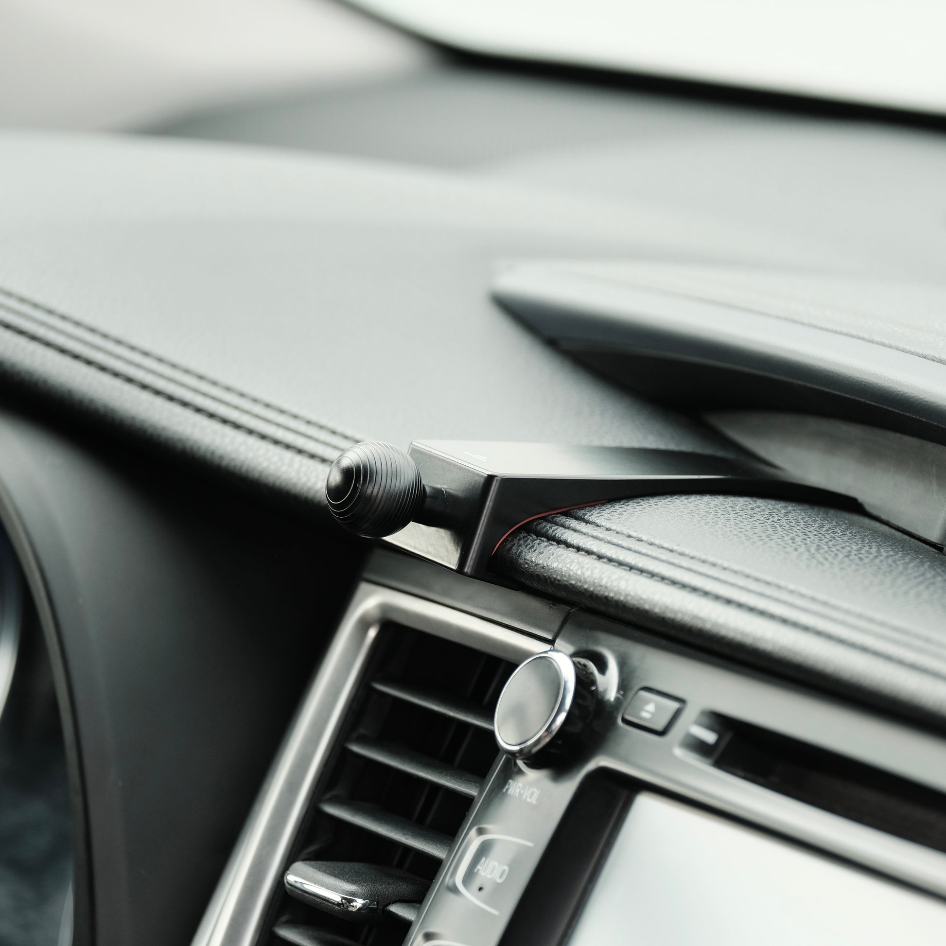 Image of Offroam Mounting Base installed securely in Toyota Highlander 2014-2019. This premium all metal phone mounting base installs easily without drilling or glue. Perfect placement without blocking screens, driver view, or air flow.
