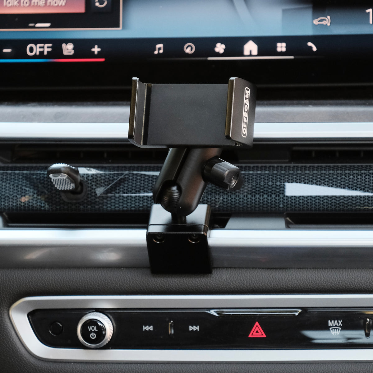 Image of Offroam Phone Mount installed securely in BMW X5 2024-2026 | X6 2024-2027 | X7 2023-2027. This premium phone mount installs easily without drilling or glue. Spring loaded Universal holder for use with any phone. Perfect placement without blocking screens, driver view, or air flow. Fully adjustable positioning.