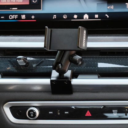 Image of Offroam Phone Mount installed securely in BMW X5 2024-2026 | X6 2024-2027 | X7 2023-2027. This premium phone mount installs easily without drilling or glue. Spring loaded Universal holder for use with any phone. Perfect placement without blocking screens, driver view, or air flow. Fully adjustable positioning.