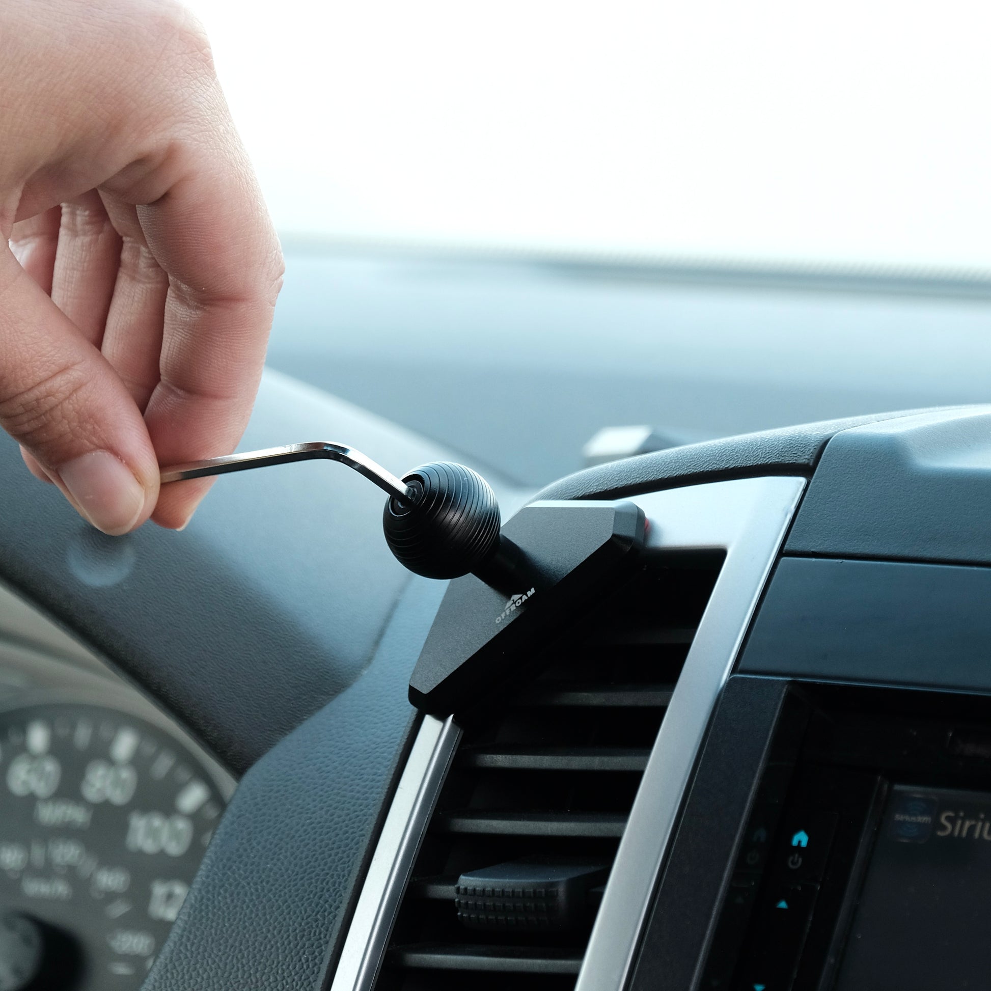 Image of Offroam Phone Mount installed securely in Nissan Frontier 2009-2021 | Xterra 2009-2015. This premium phone mount installs easily without drilling or glue. Spring loaded Universal holder for use with any phone. Perfect placement without blocking screens, driver view, or air flow. Fully adjustable positioning.