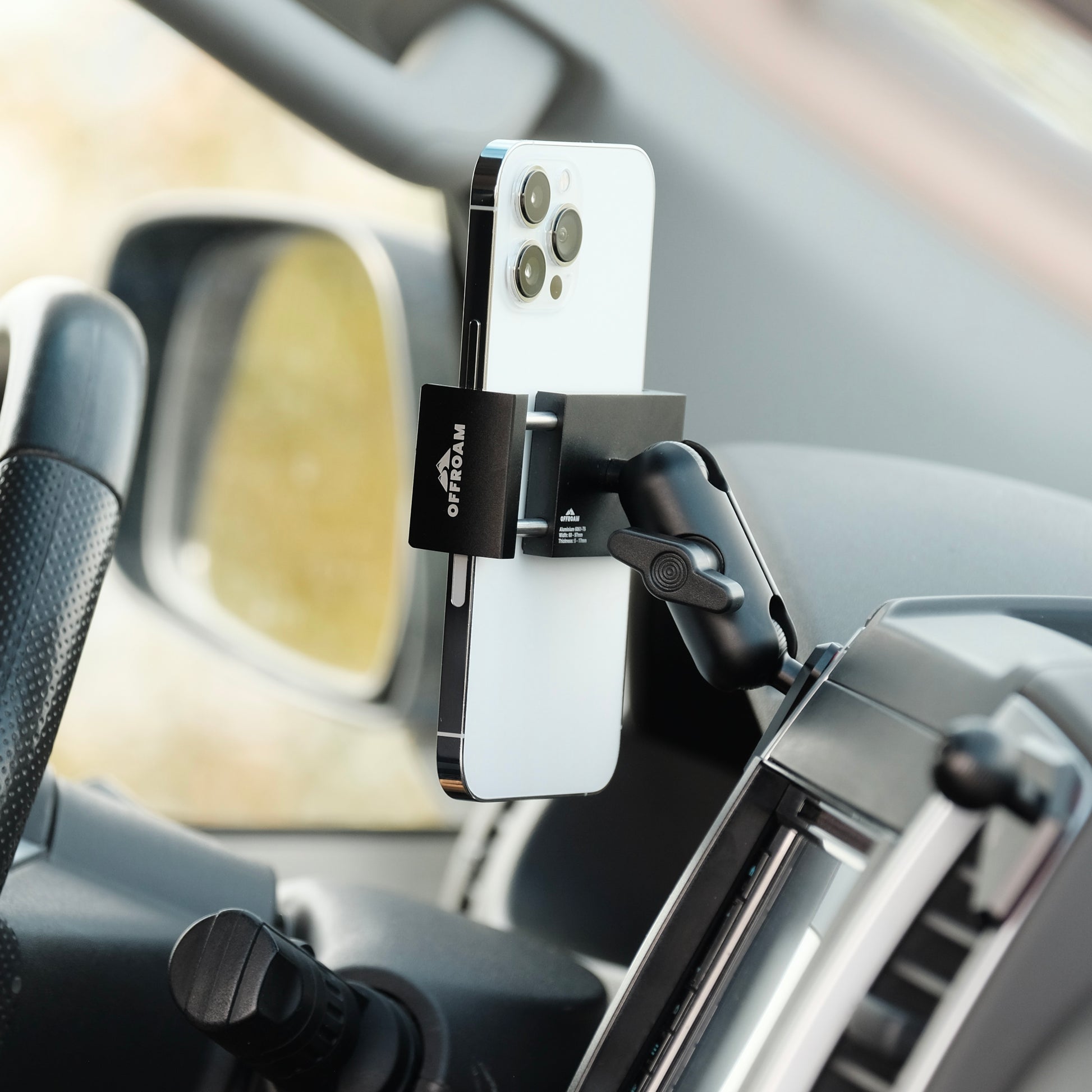 Image of Offroam Phone Mount installed securely in Ram 1500/2500/3500 2013-2018 | Ram Classic 2019-2024. This premium phone mount installs easily without drilling or glue. Spring loaded Universal holder for use with any phone. Perfect placement without blocking screens, driver view, or air flow. Fully adjustable positioning.