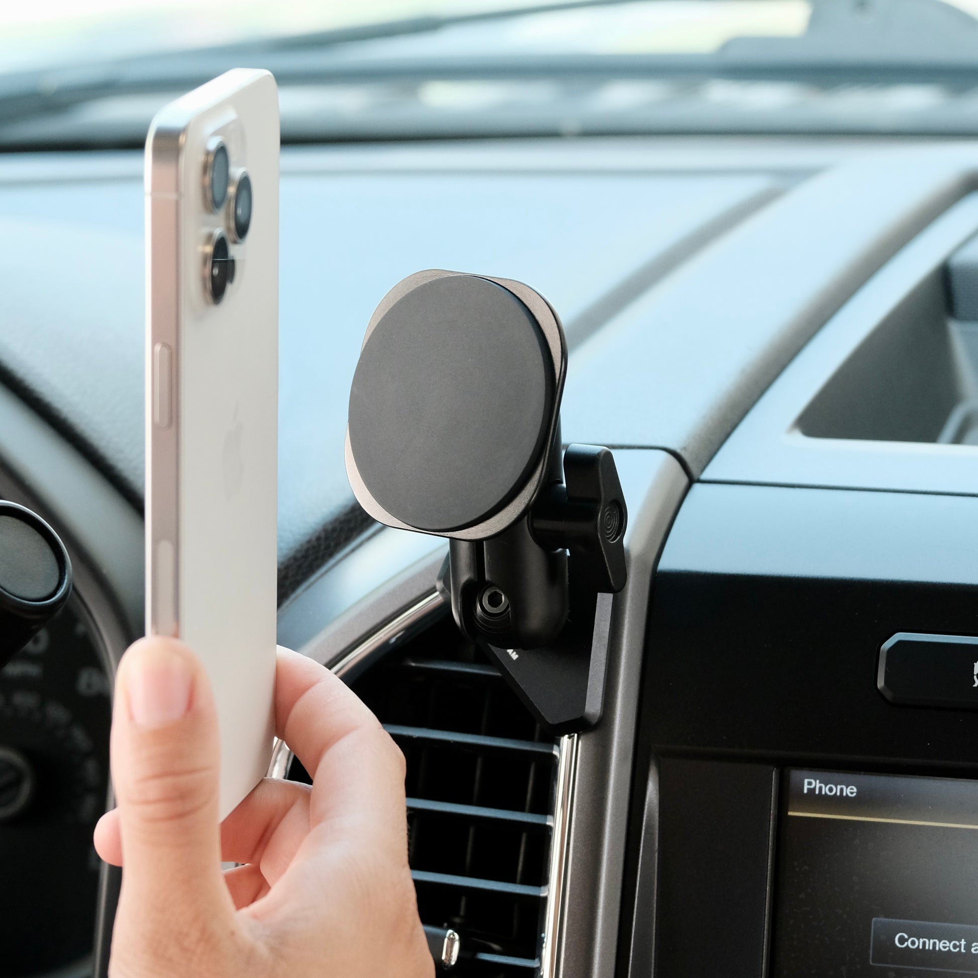 Image of Offroam MagSafe-compatible Phone Mount installed securely in Ford F-150 2015-2020 | Super Duty 2017-2021 & 2022 (XL and XLT) | Expedition 2018-2021. This premium phone mount installs easily without drilling or glue. High force magnets hold phone on any trail, road, or track. Perfect placement without blocking screens, driver view, or air flow. Fully adjustable positioning.