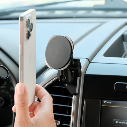 Image of Offroam MagSafe-compatible Phone Mount installed securely in Ford F-150 2015-2020 | Super Duty 2017-2021 & 2022 (XL and XLT) | Expedition 2018-2021. This premium phone mount installs easily without drilling or glue. High force magnets hold phone on any trail, road, or track. Perfect placement without blocking screens, driver view, or air flow. Fully adjustable positioning.