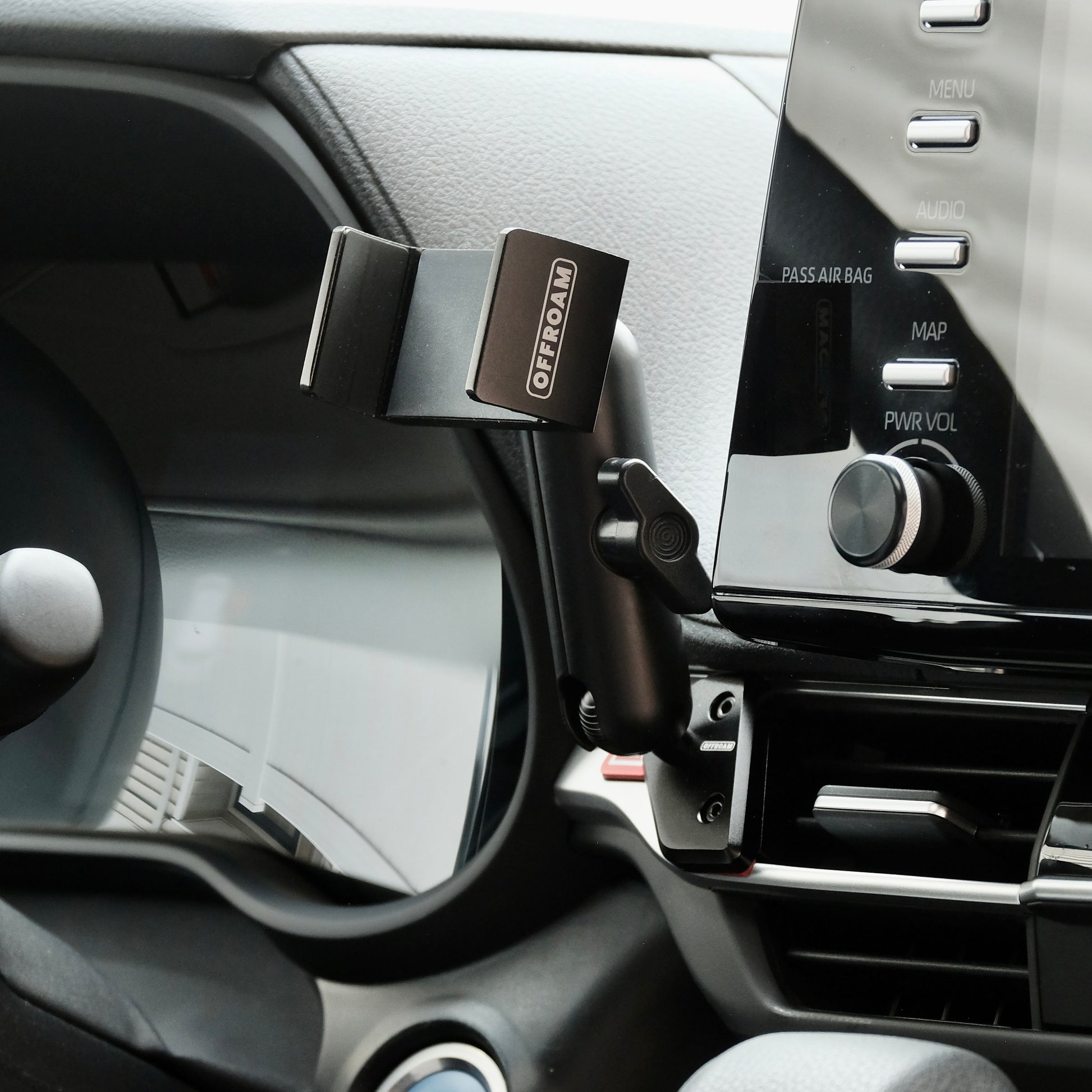 Image of Offroam Phone Mount installed securely in Toyota Sienna 2021-2026. This premium phone mount installs easily without drilling or glue. Spring loaded Universal holder for use with any phone. Perfect placement without blocking screens, driver view, or air flow. Fully adjustable positioning.