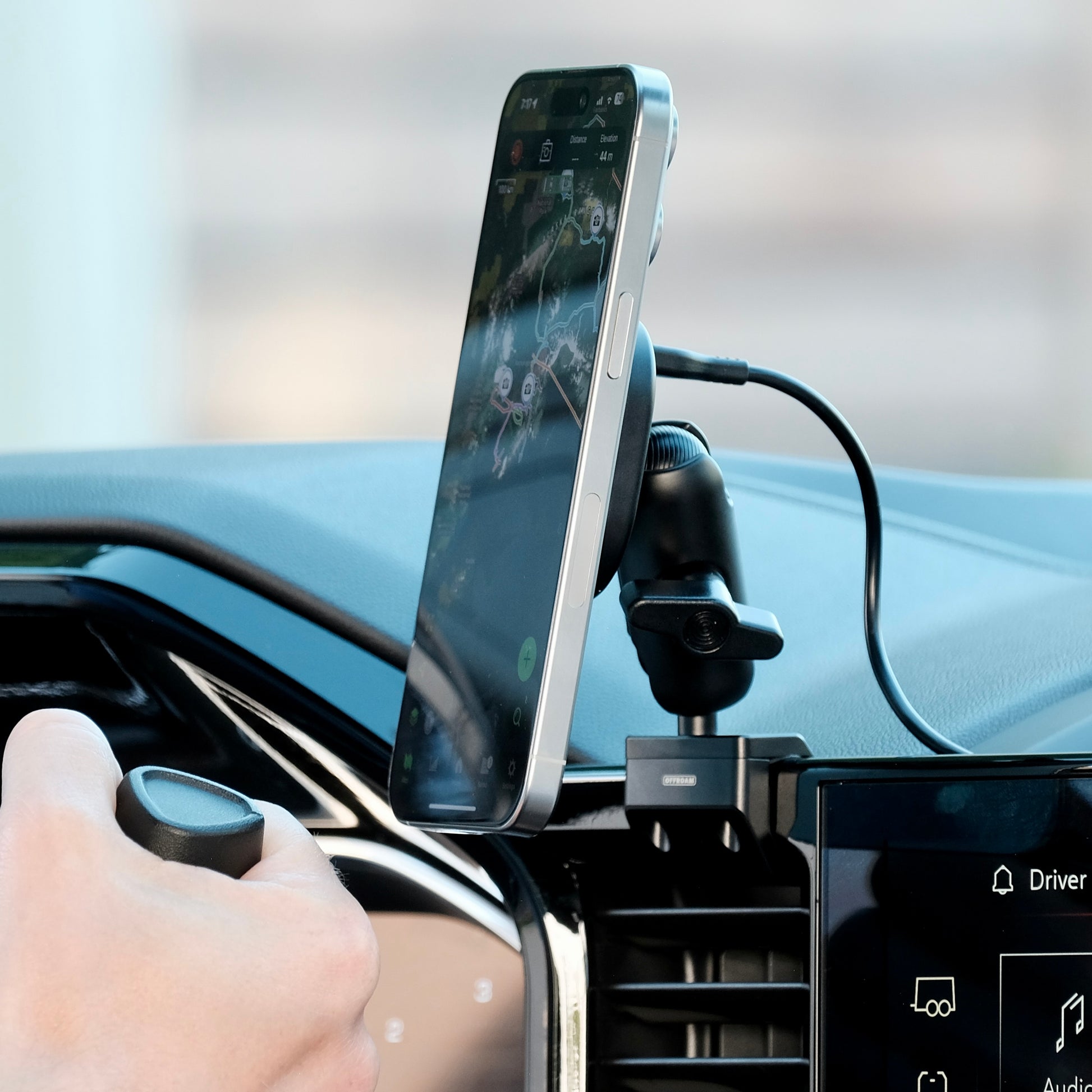 Image of Offroam MagSafe-compatible Phone Mount installed securely in Chevrolet Silverado 2022-2026 | Silverado HD 2024-2026 | GMC Sierra 1500 2022-2026 | Sierra HD 2024-2026 with 13.4-in. display. This premium phone mount installs easily without drilling or glue. High force magnets hold phone on any trail, road, or track. Perfect placement without blocking screens, driver view, or air flow. Fully adjustable positioning.
