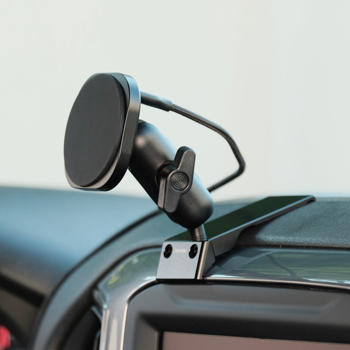 Image of Offroam MagSafe-compatible Phone Mount installed securely in Chevrolet Silverado 2019-2026 | Silverado HD 2020-2026 & GMC Sierra 1500 2019-2026 | Sierra HD 2020-2026 with 7-in.|8-in. display. This premium phone mount installs easily without drilling or glue. High force magnets hold phone on any trail, road, or track. Perfect placement without blocking screens, driver view, or air flow. Fully adjustable positioning.