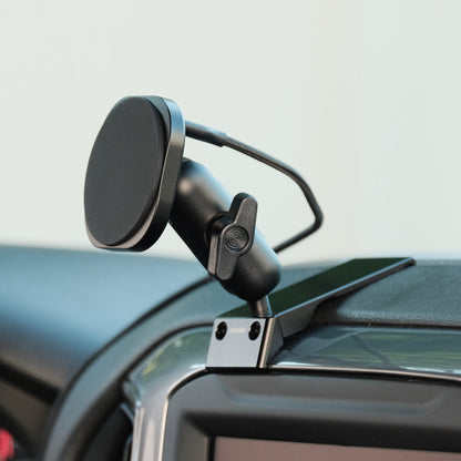 Image of Offroam MagSafe-compatible Phone Mount installed securely in Chevrolet Silverado 2019-2026 | Silverado HD 2020-2026 & GMC Sierra 1500 2019-2026 | Sierra HD 2020-2026 with 7-in.|8-in. display. This premium phone mount installs easily without drilling or glue. High force magnets hold phone on any trail, road, or track. Perfect placement without blocking screens, driver view, or air flow. Fully adjustable positioning.