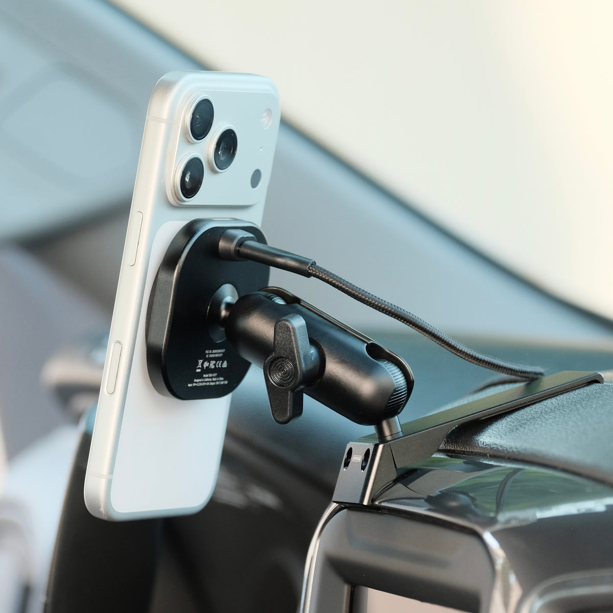 Image of Offroam MagSafe-compatible Phone Mount installed securely in Chevrolet Silverado 2019-2026 | Silverado HD 2020-2026 & GMC Sierra 1500 2019-2026 | Sierra HD 2020-2026 with 7-in.|8-in. display. This premium phone mount installs easily without drilling or glue. High force magnets hold phone on any trail, road, or track. Perfect placement without blocking screens, driver view, or air flow. Fully adjustable positioning.