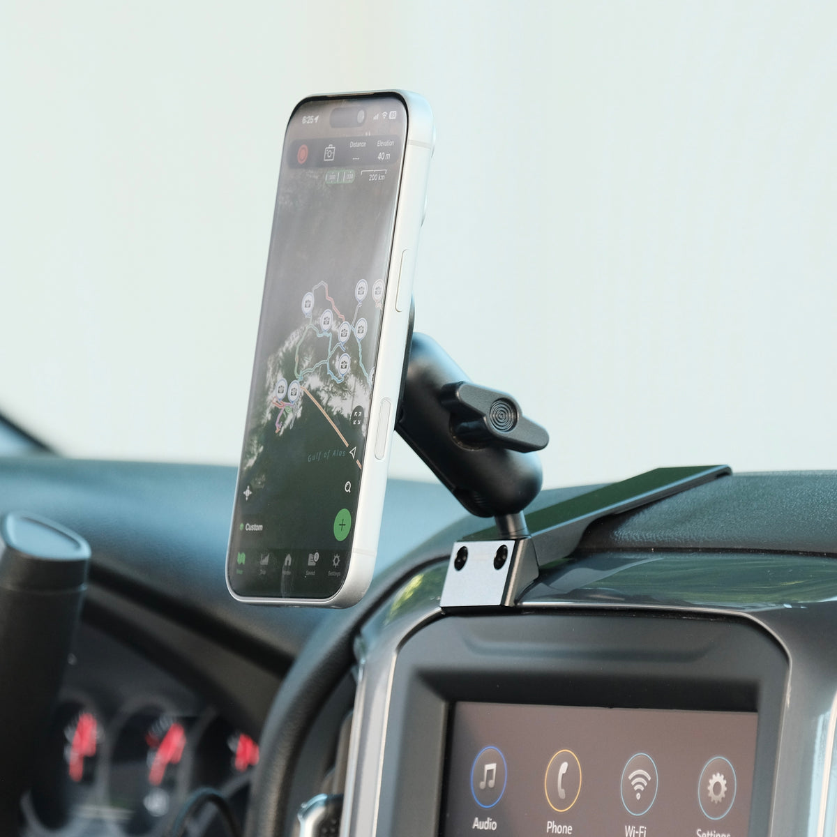 Image of Offroam MagSafe-compatible Phone Mount installed securely in Chevrolet Silverado 2019-2026 | Silverado HD 2020-2026 & GMC Sierra 1500 2019-2026 | Sierra HD 2020-2026 with 7-in.|8-in. display. This premium phone mount installs easily without drilling or glue. High force magnets hold phone on any trail, road, or track. Perfect placement without blocking screens, driver view, or air flow. Fully adjustable positioning.