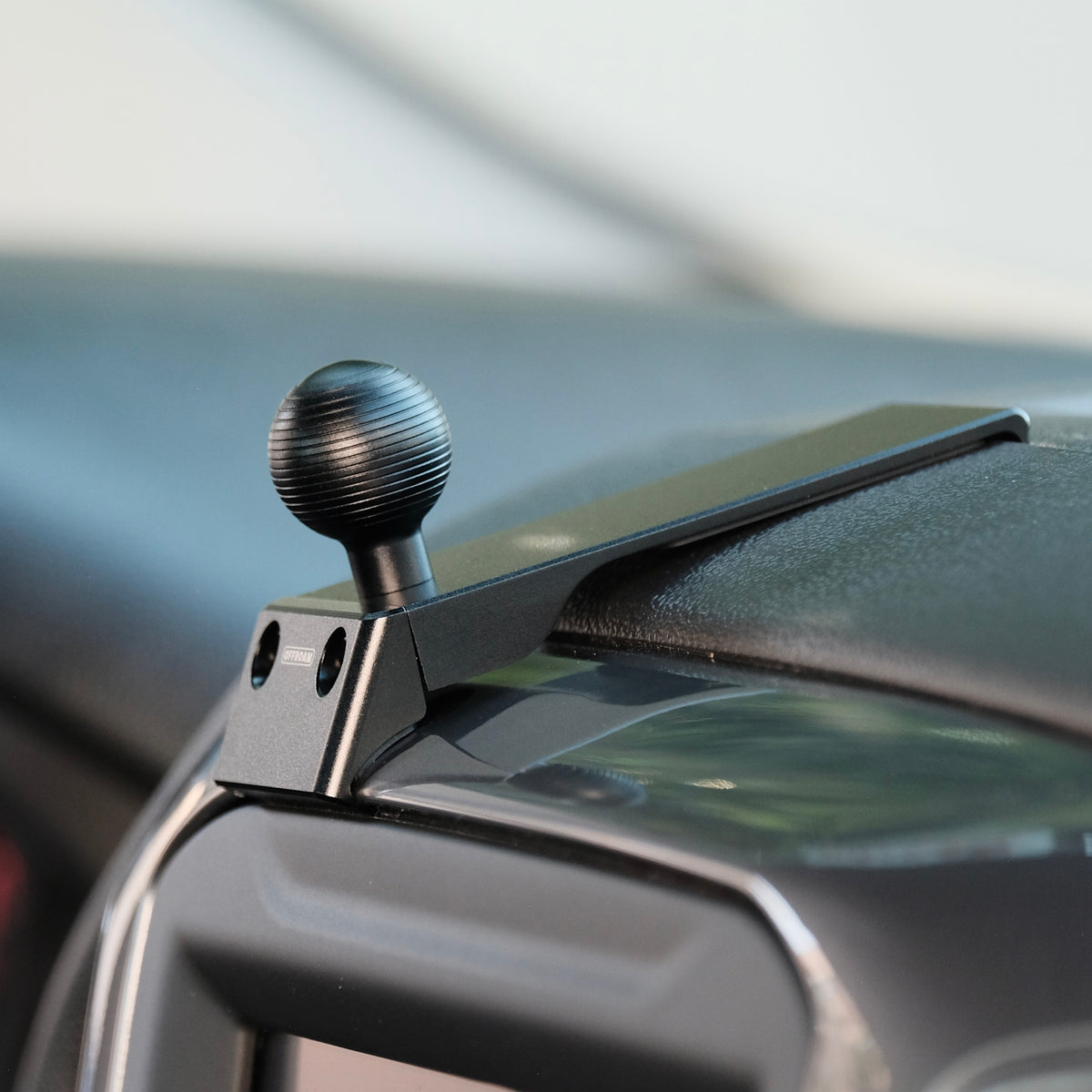 Image of Offroam Mounting Base installed securely in Chevrolet Silverado 2019-2026 | Silverado HD 2020-2026 & GMC Sierra 1500 2019-2026 | Sierra HD 2020-2026 with 7-in.|8-in. display. This premium all metal phone mounting base installs easily without drilling or glue. Perfect placement without blocking screens, driver view, or air flow.