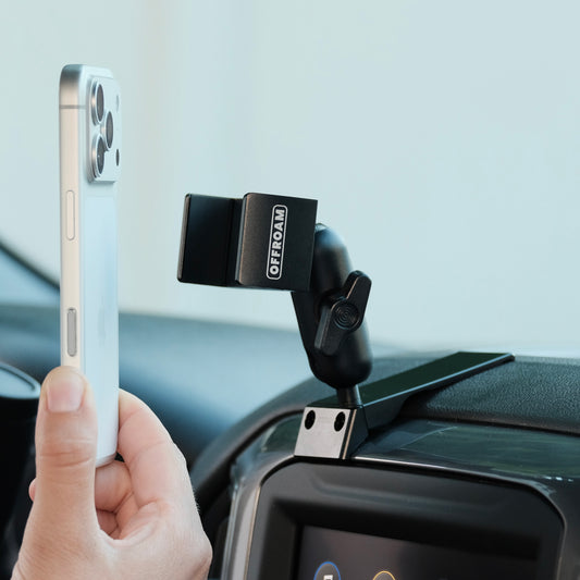 Image of Offroam Phone Mount installed securely in Chevrolet Silverado 2019-2026 | Silverado HD 2020-2026 & GMC Sierra 1500 2019-2026 | Sierra HD 2020-2026 with 7-in.|8-in. display. This premium phone mount installs easily without drilling or glue. Spring loaded Universal holder for use with any phone. Perfect placement without blocking screens, driver view, or air flow. Fully adjustable positioning.